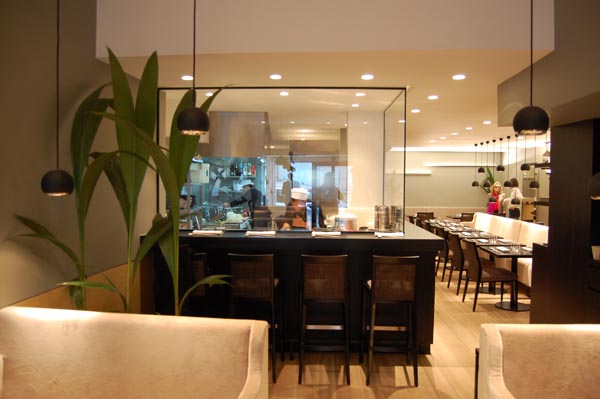 <b>TAOKAN</b> - 8, rue du Sabot - Paris VIe<br/><br/>Au travers de larges baies vitrées, les clients peuvent observer les cuisiniers s'affairer.<br/>La cuisine s'intègre au design de la salle dont la décoration est signée Olivier Lempereur.